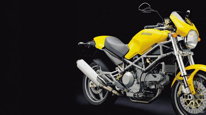 Side Pose of Ducati monster 1000 s 2004 in Yellow And Black Background